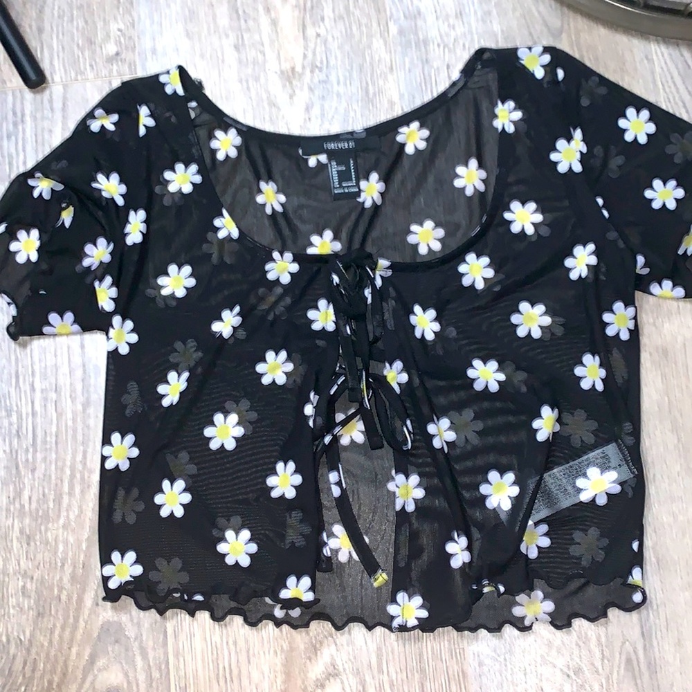 A black see through flower top. And has tied ribbons.